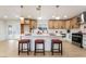 Bright kitchen features white cabinets, large island with seating, modern appliances, and stylish pendant lighting at 4237 E Twain Ave, Las Vegas, NV 89121
