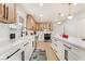 Bright kitchen features white cabinets, long countertops with modern appliances, and stylish black hardware at 4237 E Twain Ave, Las Vegas, NV 89121