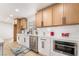 Bright kitchen features white cabinets, stainless steel appliances, and wooden upper cabinets at 4237 E Twain Ave, Las Vegas, NV 89121