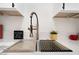 Close-up of a modern kitchen sink with a gold faucet and white countertop at 4237 E Twain Ave, Las Vegas, NV 89121