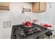 Close up of bright white kitchen features a modern stove with a pot filler faucet at 4237 E Twain Ave, Las Vegas, NV 89121