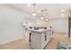 Bright kitchen features a large island with seating and modern pendant lighting overlooking open floorplan at 4237 E Twain Ave, Las Vegas, NV 89121