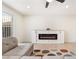 Bright living room featuring a sleek electric fireplace, and a comfortable gray sofa at 4237 E Twain Ave, Las Vegas, NV 89121