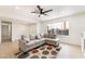 Bright living room with a gray, cushioned sofa, ceiling fan, and plenty of natural light at 4237 E Twain Ave, Las Vegas, NV 89121