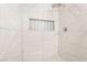 Detailed view of a tiled walk-in shower with a built-in niche and modern fixtures at 4237 E Twain Ave, Las Vegas, NV 89121