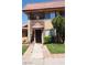 Close up of townhome entrance with terra cotta tiled roof and manicured front lawn at 4310 Lynnann Dr, Las Vegas, NV 89110