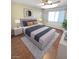 Well-staged bedroom featuring a plush bed, natural light, and minimalist decor, creating a calming space at 451 Rumford Pl, Henderson, NV 89074