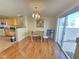 Bright dining area with a chandelier and sliding glass door leading to the patio at 451 Rumford Pl, Henderson, NV 89074