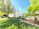 Beautiful home exterior with manicured lawn, mature trees, and bright blue skies at 451 Rumford Pl, Henderson, NV 89074