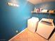 Laundry area featuring a washer and dryer with blue walls and tiled floors at 451 Rumford Pl, Henderson, NV 89074