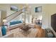 Spacious living room with high ceilings, staircase, and open layout to the dining area at 451 Rumford Pl, Henderson, NV 89074