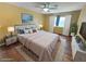 Bright, staged bedroom with a ceiling fan, plush bed, stylish decor, and ample natural light at 451 Rumford Pl, Henderson, NV 89074