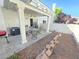 Cozy covered patio with seating area and access to a small, private yard at 451 Rumford Pl, Henderson, NV 89074