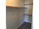 A well-organized closet featuring multiple shelves and wooden closet rods for optimal storage at 4555 E Sahara Ave # 226, Las Vegas, NV 89104