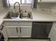 Close-up of the kitchen sink with quartz countertops and stainless steel dishwasher at 4555 E Sahara Ave # 226, Las Vegas, NV 89104