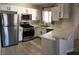 Modern kitchen with stainless steel appliances, white cabinets, and quartz countertops at 4555 E Sahara Ave # 226, Las Vegas, NV 89104