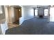 Open-concept living area with fireplace, carpeted floors, and access to a balcony at 4555 E Sahara Ave # 226, Las Vegas, NV 89104