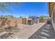 Backyard featuring desert landscaping, storage sheds, and privacy fencing at 508 Cadence View Way, Henderson, NV 89011