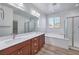 Elegant bathroom featuring dual sinks, a soaking tub, and a separate shower with a glass door at 508 Cadence View Way, Henderson, NV 89011