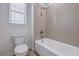 Well-lit bathroom featuring a combination shower and tub and a window at 508 Cadence View Way, Henderson, NV 89011