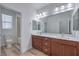 Bathroom with double vanity, wood-look floors, quartz countertop and large mirror at 508 Cadence View Way, Henderson, NV 89011
