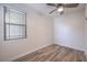 This bedroom features wood-look floors, a ceiling fan, and a bright window at 508 Cadence View Way, Henderson, NV 89011