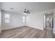 Large, open bedroom with wood-look floors, natural light and a ceiling fan at 508 Cadence View Way, Henderson, NV 89011