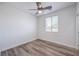 This bedroom features wood-look floors, a ceiling fan, and a bright window at 508 Cadence View Way, Henderson, NV 89011