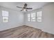 This bedroom features wood-look floors, a ceiling fan, and multiple windows at 508 Cadence View Way, Henderson, NV 89011