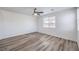 This bedroom features wood-look floors, a ceiling fan, and a bright window at 508 Cadence View Way, Henderson, NV 89011