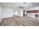 Open-concept living room with wood-look floors and seamless flow to the kitchen at 508 Cadence View Way, Henderson, NV 89011