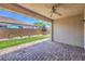 Relaxing covered patio featuring brick flooring, ceiling fan, and a view of the well maintained backyard at 508 Cadence View Way, Henderson, NV 89011