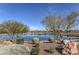 Scenic view of the community pond with lush landscaping and distant mountain views at 508 Cadence View Way, Henderson, NV 89011