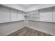 Walk-in closet with wood-look floors, white walls and multiple shelves at 508 Cadence View Way, Henderson, NV 89011