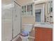 Bathroom with glass-enclosed shower, wood vanity, and white toilet at 5109 Midnight Oil Dr, Las Vegas, NV 89122