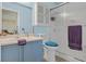 Bathroom featuring a blue vanity, toilet, and a glass-enclosed shower at 5109 Midnight Oil Dr, Las Vegas, NV 89122