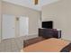 Spacious bedroom with neutral tones, tile floors, and a modern dresser at 5109 Midnight Oil Dr, Las Vegas, NV 89122