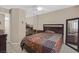Bedroom featuring neutral walls, tiled floors, white shutters, and ceiling fan at 5109 Midnight Oil Dr, Las Vegas, NV 89122