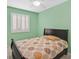Bedroom featuring light green walls, tiled floors, white shutters, and ceiling fan at 5109 Midnight Oil Dr, Las Vegas, NV 89122
