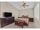Cozy bedroom with neutral walls, tiled floors, and a ceiling fan at 5109 Midnight Oil Dr, Las Vegas, NV 89122