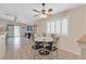 Bright dining area featuring tile floors, plantation shutters, and a decorative ceiling fan at 5109 Midnight Oil Dr, Las Vegas, NV 89122