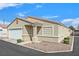 Well-maintained single-story home with a two-car garage, desert landscaping, and private driveway at 5109 Midnight Oil Dr, Las Vegas, NV 89122