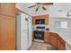 Eat-in kitchen with wooden cabinets, gas range, and white appliances at 5109 Midnight Oil Dr, Las Vegas, NV 89122
