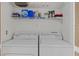 Laundry room with washer, dryer, and storage shelf at 5109 Midnight Oil Dr, Las Vegas, NV 89122