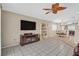 Spacious living room with tile flooring, ceiling fan, and plenty of natural light at 5109 Midnight Oil Dr, Las Vegas, NV 89122