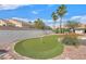 Enjoy outdoor living with a backyard putting green and a low wall ensuring privacy at 5109 Midnight Oil Dr, Las Vegas, NV 89122