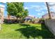 Lush, green backyard showcasing a well-maintained lawn, mature shade tree, and desert landscaping at 5725 Cedar Ave, Las Vegas, NV 89110
