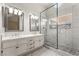 Updated bathroom with double sinks and a glass-enclosed shower at 5725 Cedar Ave, Las Vegas, NV 89110