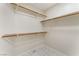 Large walk-in closet offers ample storage space with built-in shelves and marble patterned tile at 5725 Cedar Ave, Las Vegas, NV 89110