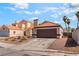 Single-story home featuring desert landscaping and a two-car garage at 5725 Cedar Ave, Las Vegas, NV 89110